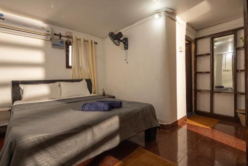 a bedroom with a large bed in a room at Forget Me Not Resort in Agonda