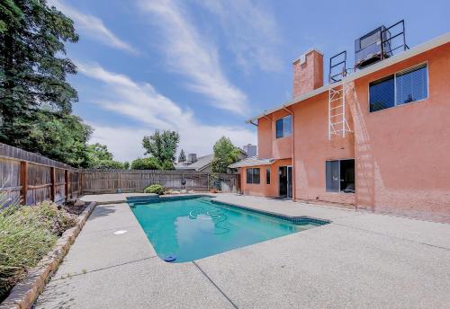 a swimming pool in front of a house at Cozy Room#1 Best Moscato in Clovis