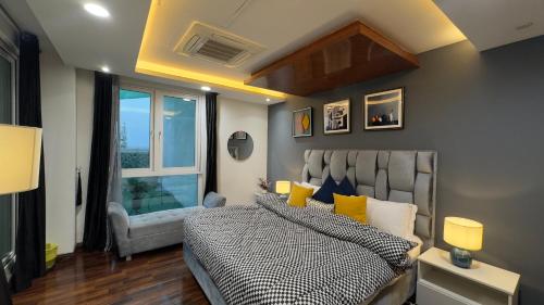 a bedroom with a bed and a window at Gold Crest Executive Hotel Apartments City View DHA Lahore in Lahore
