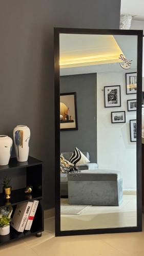 a mirror reflecting a bedroom with a bed in a room at Gold Crest Executive Hotel Apartments City View DHA Lahore in Lahore