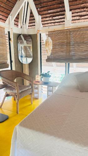 a bedroom with a bed and a chair and a mirror at Chalet, Free Suzuki Jimny 4x4, Port pick-up and drop-off service, and Unlimited Massage Chair Use in Maria