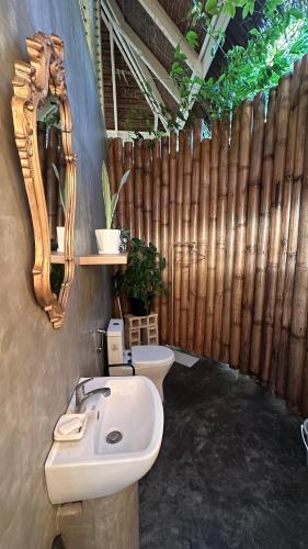 a bathroom with a sink and a mirror and a toilet at Chalet, Free Suzuki Jimny 4x4, Port pick-up and drop-off service, and Unlimited Massage Chair Use in Maria