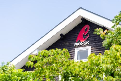 a sign on the side of a building with trees at Grampus Inn Shirahama in Shirahama