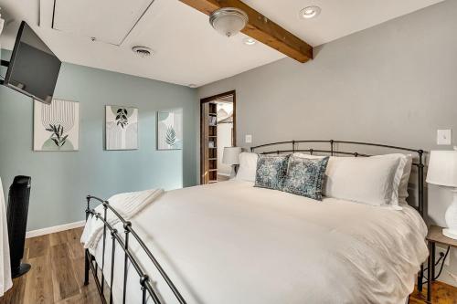 a bedroom with a large bed and a tv at Craig Beach Cottage Hot Tub 5 Min Walk to Beach in Lake Milton