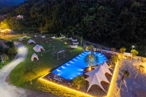 an overhead view of a resort with a pool and tents at Glamping Resort-At National Forest Park with Free Shuttle in Zhangjiajie