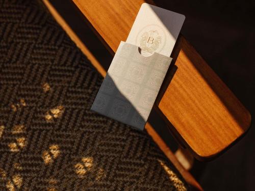 a piece of paper sitting on top of a wooden bench at Balfour Miami Beach, a Morgans Originals hotel in Miami Beach