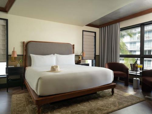 a bedroom with a large bed and a large window at Balfour Miami Beach, a Morgans Originals hotel in Miami Beach