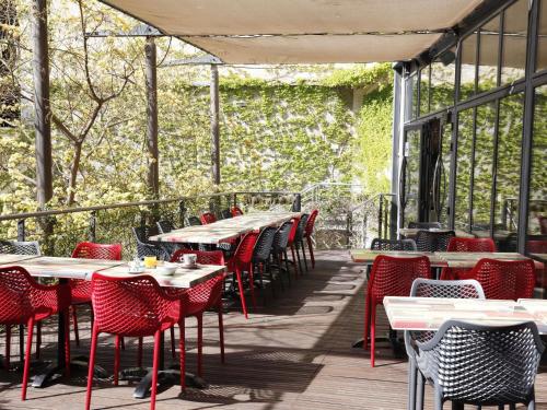 a row of tables and chairs on a patio at Hôtel Marseille Centre Gare Saint-Charles in Marseille