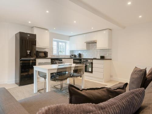 a living room with a table and a kitchen at The Norfolk-Uk41442 in Brandon