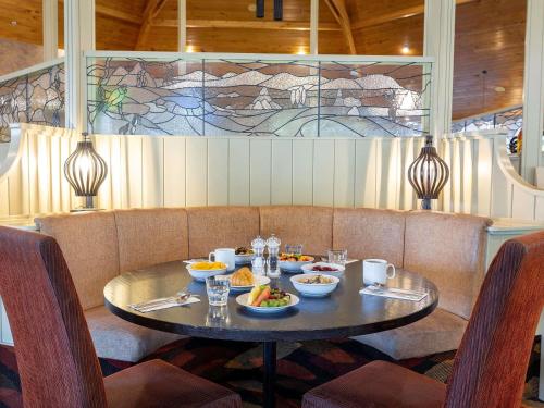 a table with bowls of food on it in a restaurant at Wairakei Resort Taupo in Taupo