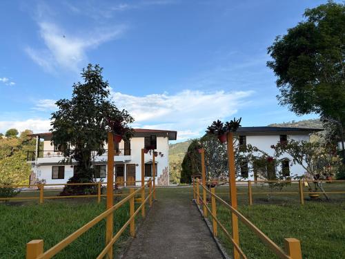 a wooden fence in front of a building at Hotel Campestre El Triunfo in San Agustín