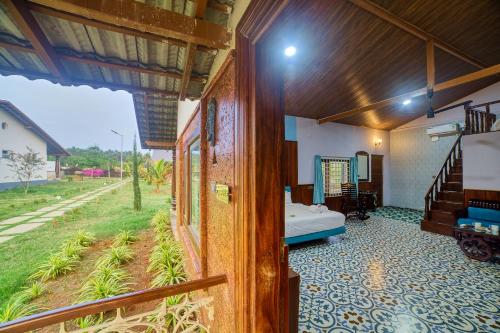 a room with a bed and a view of a field at Vintage Trails By Ilara in Alūr