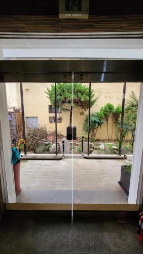 an open glass door with a view of a courtyard at 스테이 마산 in Changwon