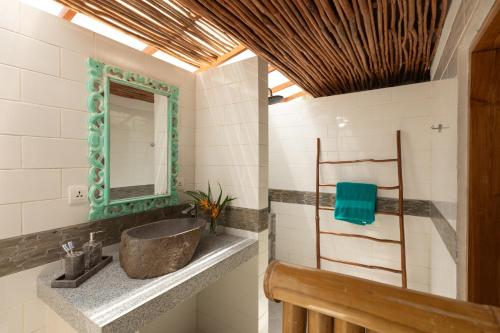 a bathroom with a sink and a mirror at The New Gili Kolanta Indah in Gili Air