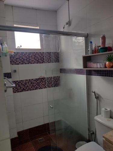 a bathroom with a glass shower with a toilet at Apartamento Classic in Belém