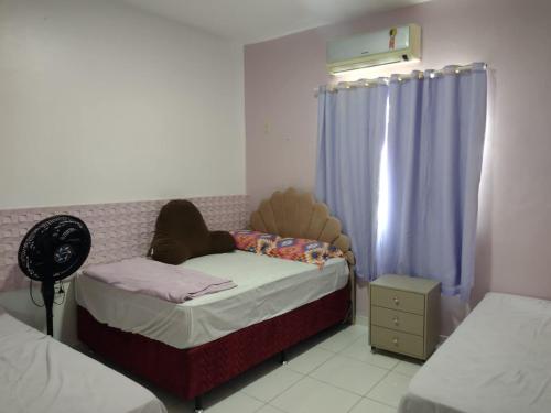 a small bedroom with a small bed and a window at Apartamento Classic in Belém
