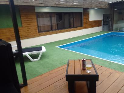 a swimming pool with a table and a drink on a table sidx sidx at Casa Bernardo in São José