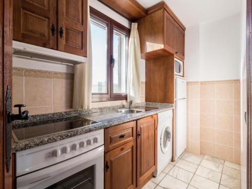 a kitchen with a sink and a dishwasher at Nature, and Comfort in Pozo Alcón in Cuenca