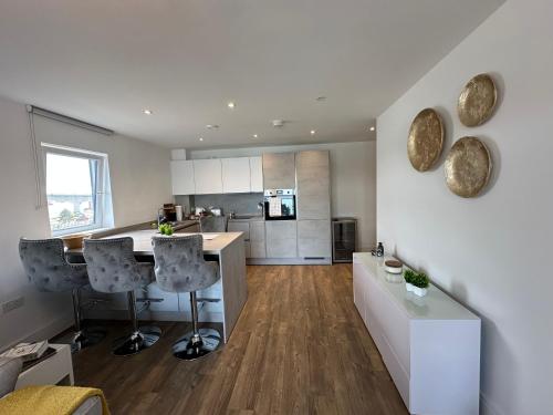 a kitchen with a table and chairs in a room at Waterfront - long stay apartment in Southampton