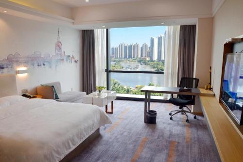 Ένα ή περισσότερα κρεβάτια σε δωμάτιο στο Huizhou Faithland Atin Hotel