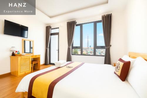 a hotel room with a bed and a desk and window at S79 Hoa Dang Hotel Dalat in Da Lat