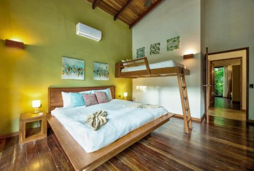 a bedroom with a bed with a bunk bed at Shawandha Villas in Punta Uva