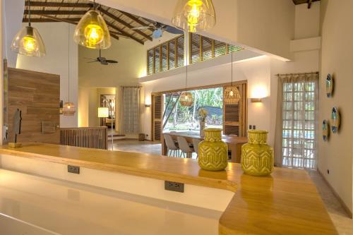 a kitchen with a table and a dining room at Shawandha Villas in Punta Uva