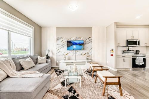 a living room with a couch and a table at Cozyhub Vacation Rental Calgary-3Bedroom with AC in Calgary