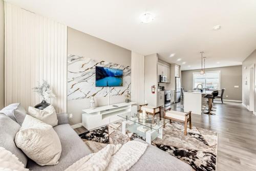 a living room with a couch and a table at Cozyhub Vacation Rental Calgary-3Bedroom with AC in Calgary