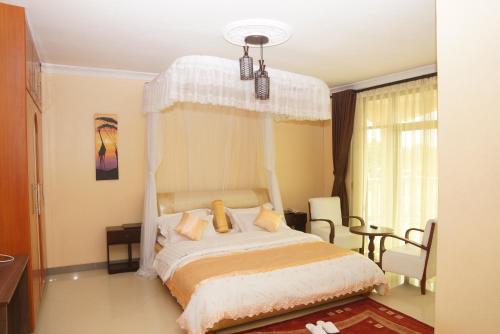 Postel nebo postele na pokoji v ubytování Nican Resort Hotel Seguku Entebbe
