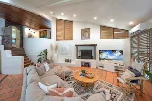 a living room with a couch and a table at Little Cove 4BR Home, Pool, Pool table, Sleeps 16 in Noosa Heads