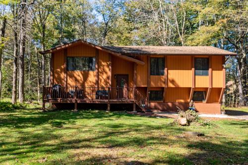 a cabin in the woods with a large yard at Serenity Grove Game Room Fire Pit Dog Friend in Pocono Pines