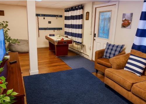 a living room with a couch and a pool table at Poconos Getaway with Hot Tub-Close to Attractions, Perfect for Family &Friends! in Blakeslee