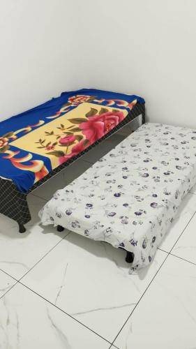 a bed sitting on top of a white floor at Apartamento Solar dos Pampas in Guaíba