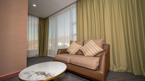 a living room with a couch and a table at Amgun Hotel Ulaanbaatar in Ulaanbaatar