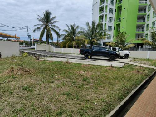 a truck parked in a parking lot next to a building at Homezstay Merdeka Miri in Miri