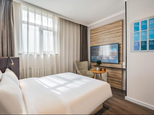 Katil atau katil-katil dalam bilik di Hanting Premium Hotel Beijing South Railway Station Majiapu