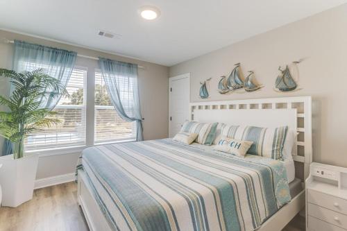 a bedroom with a large bed and a window at Front row Seat at 'The Sandy Rose' in Biloxi