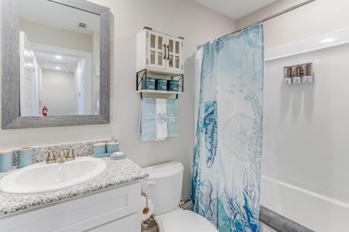 a bathroom with a sink and a toilet and a shower at Front row Seat at 'The Sandy Rose' in Biloxi