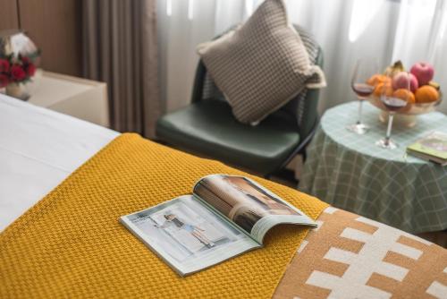 a book sitting on top of a bed with a chair at 尚品9号海景民宿Seaview Hotel in Xiamen