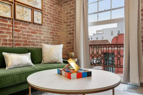 a living room with a couch and a table at Modern One Bedroom with Balcony in New Orleans