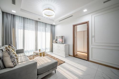 a living room with a couch and a large window at The Landmark Luxury - Apartment in Ho Chi Minh City