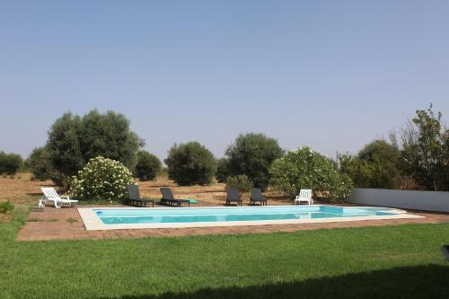 a swimming pool with lounge chairs at Quinta do Sobreiro in Reguengos de Monsaraz