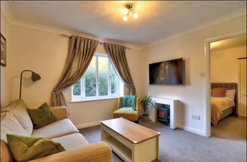 a living room with a couch and a bed at Stylish 1 Bedroom Apartment with Free Parking and Links to London & Essex in Stifford