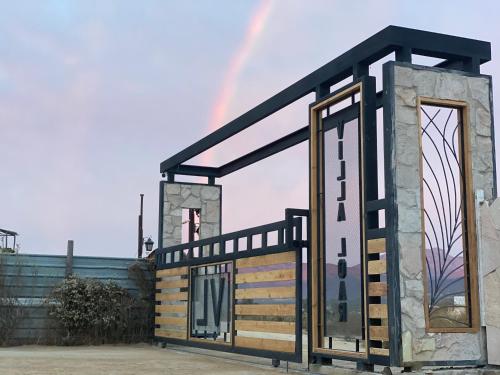 a tiny house with a rainbow in the background at Starlight bungalow Queen 5 in Ensenada