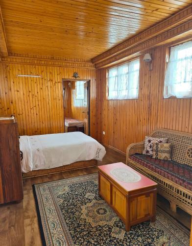 a bedroom with a bed and a couch in a room at SEWANS PLACE Homestay in Mirik