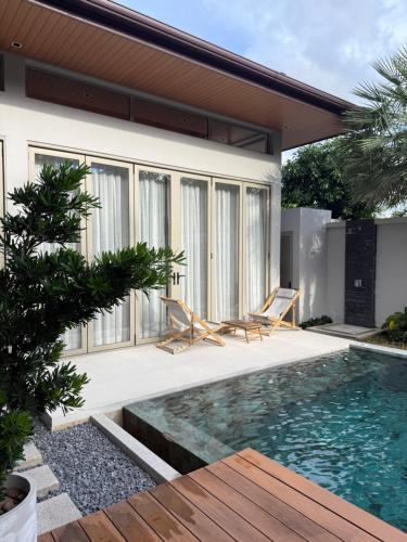 a villa with a swimming pool and a house at Luxury Villa Phuket in Phuket
