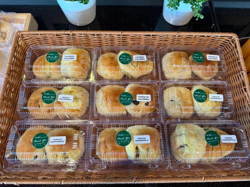 a basket full of pastries with green labels on them at GrandWara Khao Yai แกรนด์วารา เขาใหญ่ in Ban Nong Song Hong