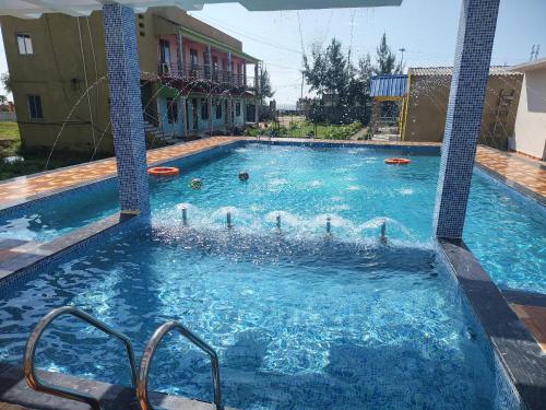 a large swimming pool with some frisbees in it at Sea Smile Inn in Mandarmoni