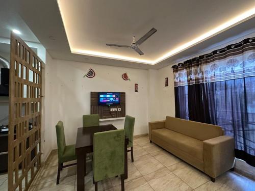 a living room with a couch and a table at The Oxford Street Stays in Zirakpur